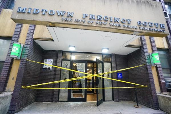 A photo of the shattered windows at Midtown South Precinct stationhouse.