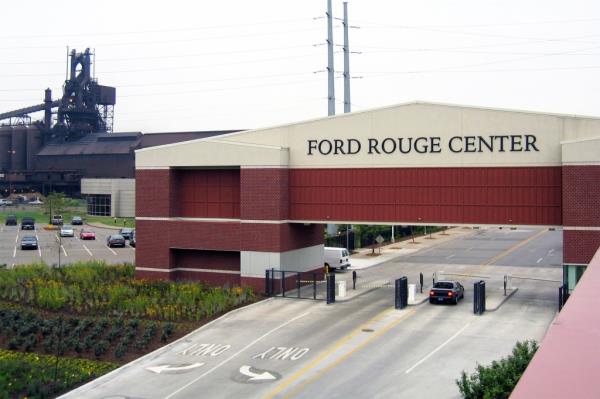 A car parked in a parking lot at the Ford Rouge plant in Michigan, a symbol of the eco<em></em>nomy and deindustrialization issues.