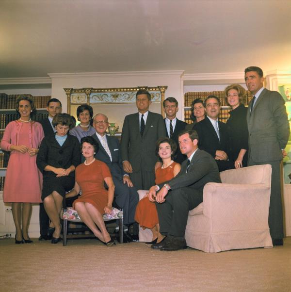 Seated (l to r) are his sister Mrs. R. Sargent Shriver; his parents Mr. and Mrs Joseph P. Kennedy; his wife Jacqueline; brother Edward Kennedy;. Standing (l to r) are sister-in-law Mrs. Robert F. Kennedy; brother-in-law Stephen Smith; Mrs. Smith; JFK; brother Robert; sister Mrs. Peter Lawford; R. Sargent Shriver; Mrs. Edward Kennedy and Peter Lawford.