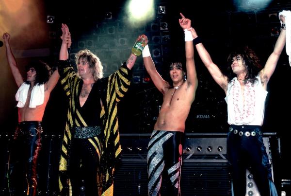 Ozzy Osbourne and bandmates Phil Soussan, Randy Castillo, and Jake E. Lee taking a bow on stage at the Poplar Creek Music Theater, Chicago, 1986.