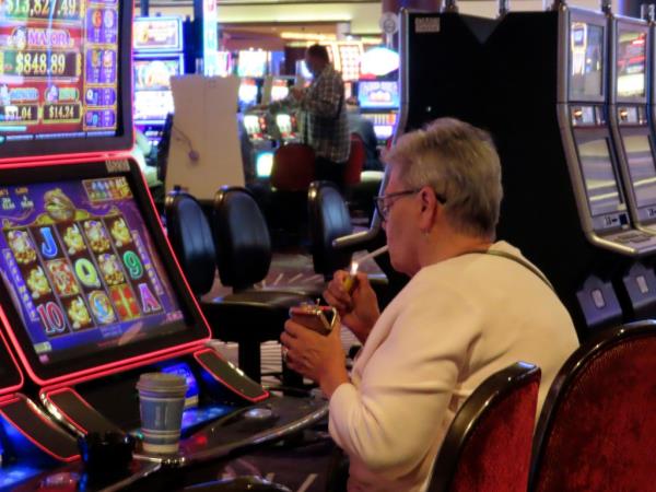 A gambler lights up at a slot machine in Harrah's Casino in Atlantic City on Sept. 29, 2023.