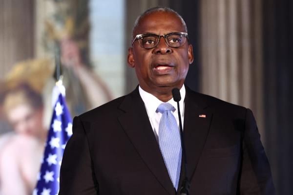US Defense Secretary Lloyd Austin speaking at a podium during the AUKUS Defense Ministerial Meeting in London, 2024