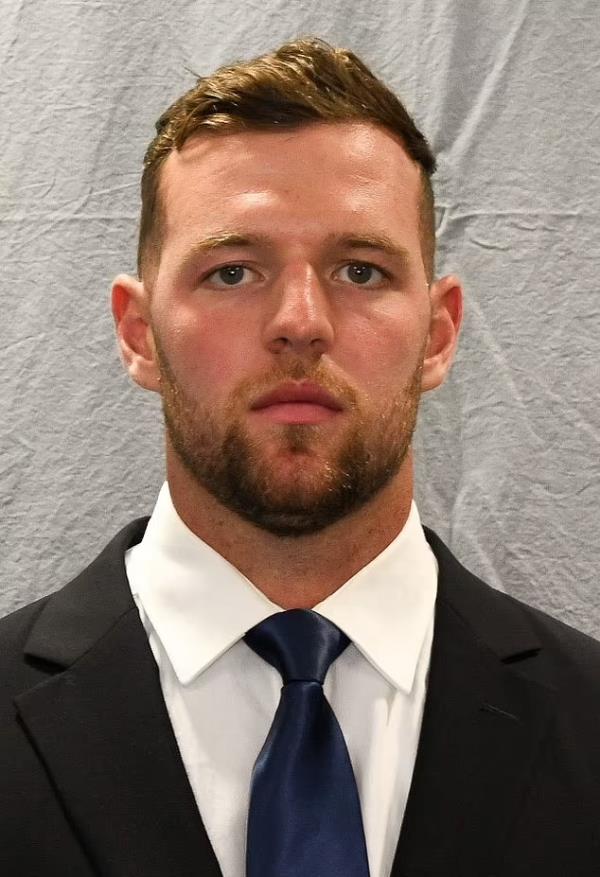 Kyle Mullen, from Mo<em></em>nmouth Hawks, wearing a suit and tie