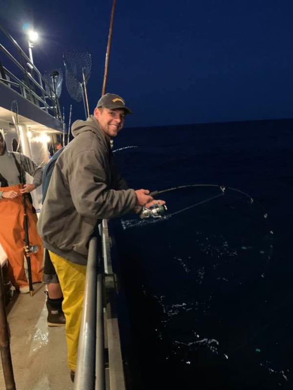 A photograph of deceased Navy SEAL, Kyle Mullen, holding a fishing pole.