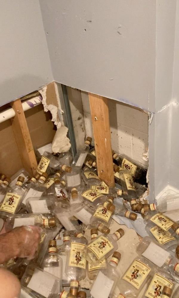 Rum bottles coming out of wall