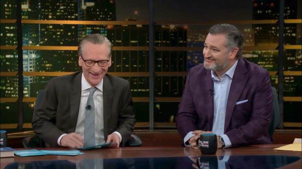 Bill Maher and Ted Cruz sitting behind a table