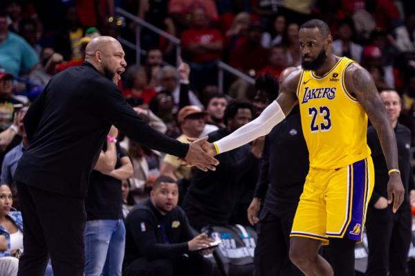 Los Angeles Lakers forward LeBron James (23) reacts after a play with  head coach Darvin Ham against the New Orleans Pelicans during the second half of a play-in game of the 2024 NBA playoffs at Smoothie King Center on April 16, 2024. 