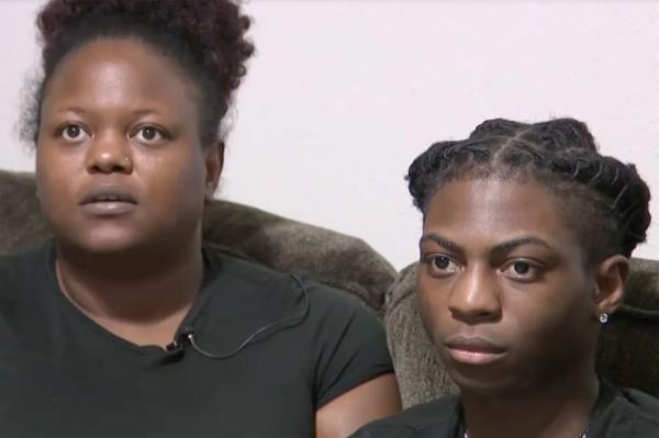 Two people on TV. One person has dreadlocks.