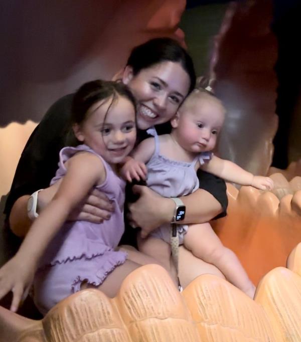 Haley Sisk holding her two children, Everly and Ella, at Disney World, Orlando, Florida