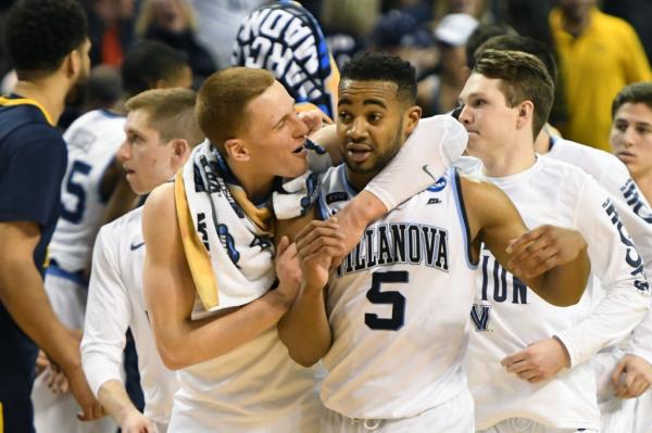 Do<em></em>nte DiVincenzo and Phil Booth of the Villanova celebrates a win after the 2018 NCAA Men's Basketball Tournament East Regio<em></em>nal against the West Virginia Mountaineers.