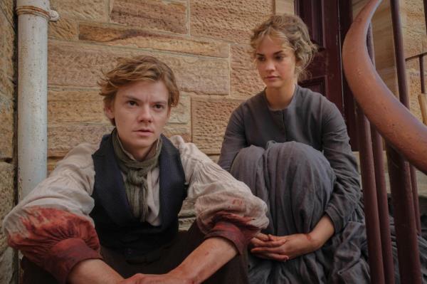 Jack Dawkins (Thomas Brodie-Sangster) and Lady Belle Fox (Maia Mitchell) next to each other, looking ahead. 