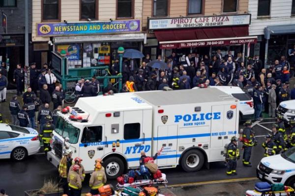 FILE - Emergency perso<em></em>nnel gather at the entrance to a subway station in the Brooklyn borough of New York, after a gunman filled a rush-hour subway train with smoke and shot multiple people, April 12, 2022. Frank James, who sprayed the inside of a New York City subway train with gunfire and then slipped away in a stunned crowd, is set to be sentenced Thursday, Oct. 5, 2023, in the morning rush-hour attack. (AP Photo/John Minchillo, File)