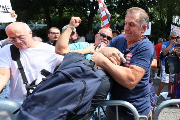 A counter protestor gets into a physical co<em></em>nfrontation with an anti-migrant protestors during a rally and protest outside of Gracie Mansion on Sunday.