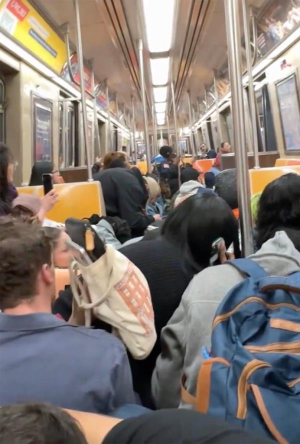 Commuters are pictured trying to get away from the fight.