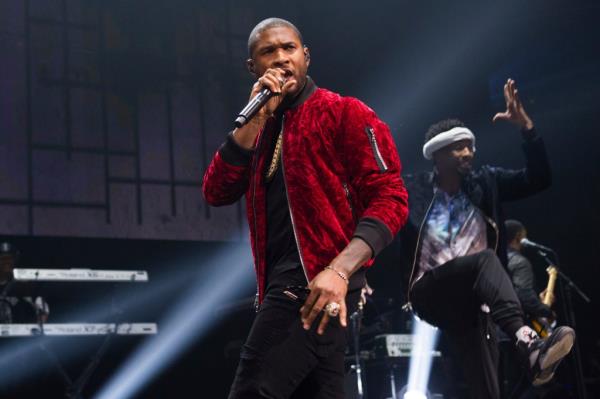 Photo of Usher in a red jacket.