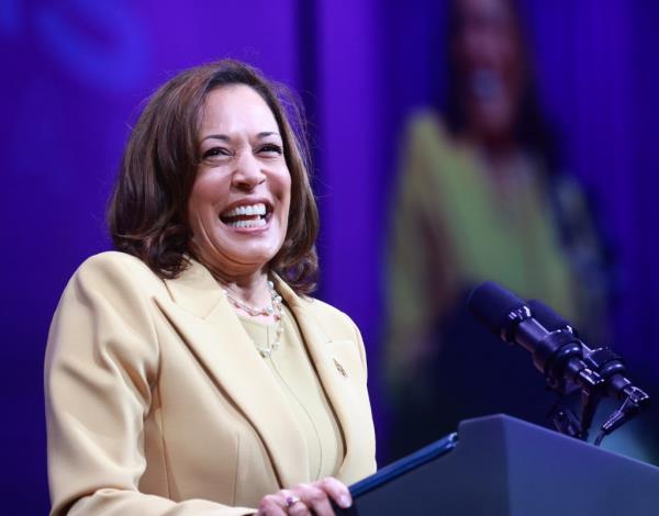 Vice President Kamala Harris smiling at the podium during the 20th Quadrennial Co<em></em>nvention of the Women's Missio<em></em>nary Society of the African Methodist Episcopal Church