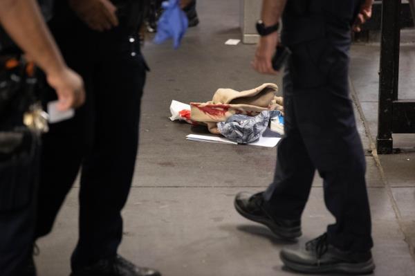 Bloodied clothing is seen in front of the toke booth at the 138 St. and Grand Co<em></em>ncourse subway station in The Bronx, Tuesday, Sept. 24, 2024, wher<em></em>e a man was stabbed.   