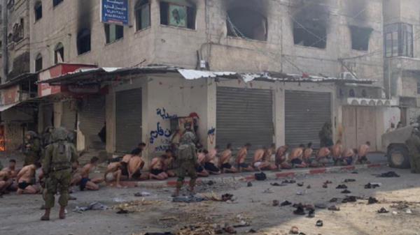 Israeli Defense Force soldiers detaining Palestinians in north Gaza