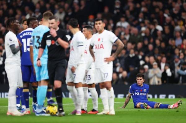 Enzo Fernandez lies on the ground after suffering an injury whilst playing for Chelsea against Tottenham