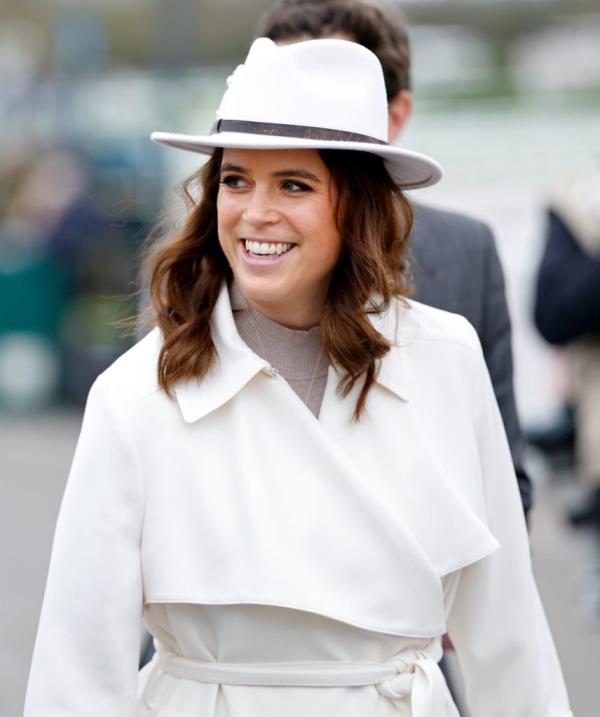 Princess Eugenie in a white coat and hat attending Style Wednesday at the Cheltenham Festival, March 2024.