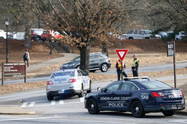Police block traffic and investigate at the UGA intramural Fields after the body of Laken Hope Riley was found near a lake. 