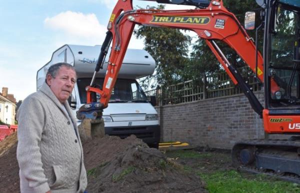 Michael Garman ,69, who lives on Kirkley Park Road in Lowestoft. Release date - 20/10/23. See SWNS story SWLNmast. A man is embroiled in a bitter row with workers from a telecoms company over plans to build a 5G mast on a grass verge outside his home. Michael Garman, 69, says he is the owner of a patch of grassy land outside his house in Lowestoft, Suffolk. In March, East Suffolk Council gave permission to Cignal Infrastructure Limited to install a 15m mast on the site to provide 3G, 4G and 5G to the area. A spokesperson said the council sent a letter to all households in the immediate area, including Mr Garman's house, and that a site notice was put up on January 13.