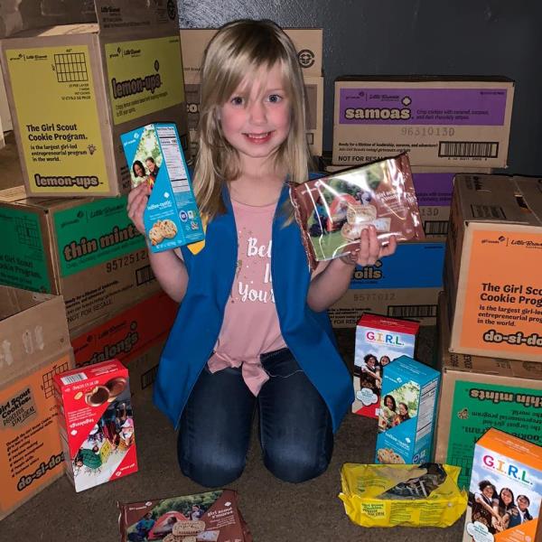 Vada Carawan holding Girl Scout coo<em></em>kies as a little girl