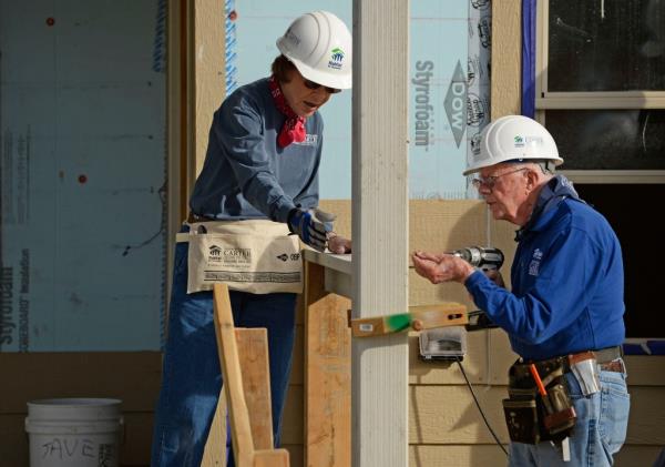 Jimmy and Rosalynn Carter working on a Habitat for Humanity home in Denver on Oct. 9, 2013.