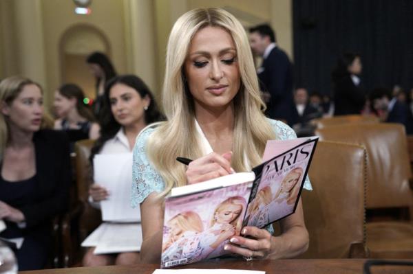 Paris Hilton was seen signing books during the hearing.