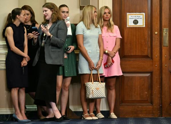 Co<em></em>ngressional staff (L) and fans of US media perso<em></em>nality Paris Hilton wait  as Hilton arrives to testify at a House Committee on Ways and Means hearing on 
