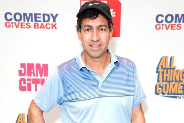 Series creator Steve Dildarian. He's posing in a blue, open-neck polo shirt and wearing a black ba<em></em>seball cap.