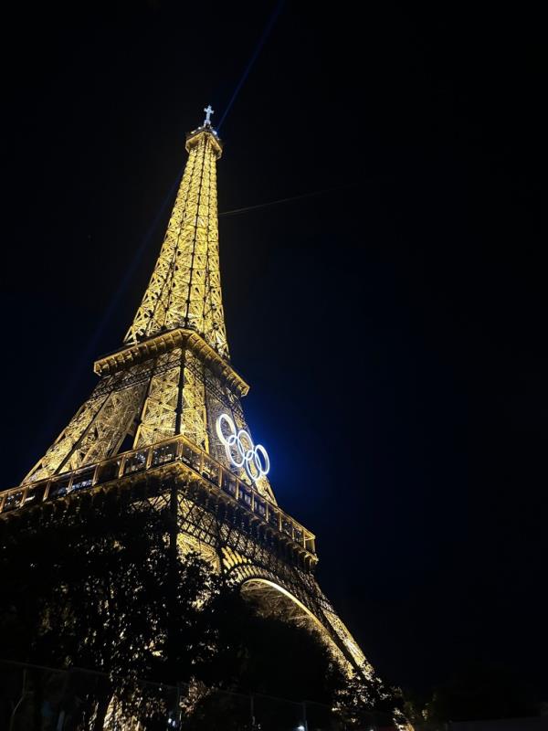 The Eiffel Tower illuminated with the Olympics logo on it.
