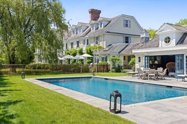 A pool in front of a house at 540 Halsey Neck Lane, Southampton, NY, featured in 2024 summer exclusives and upcoming 2025 attractions in the Hamptons.