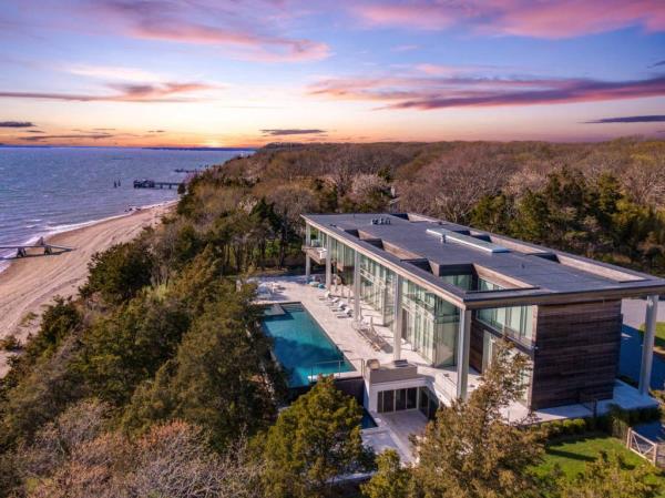 A house with a pool and trees by the waterfront located at Sunset Beach Road, Sag Harbor, New York