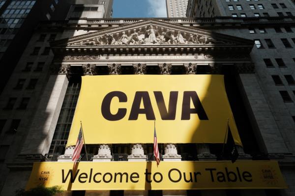 A banner for the Mediterranean restaurant chain Cava is displayed outside of the New York Stock Exchange on Thursday.