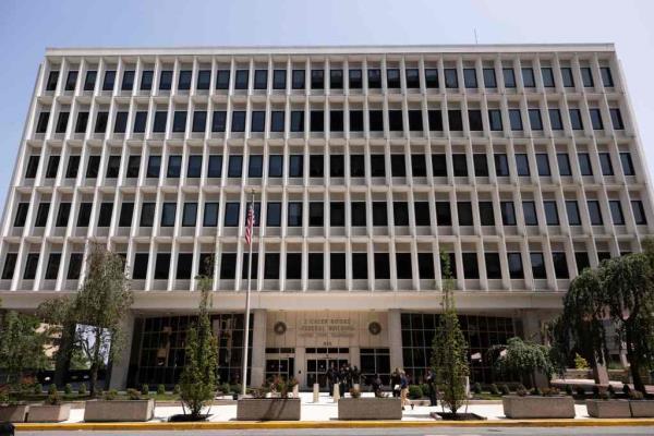 People walk in front of the J. Caleb Boggs Federal Building in Wilmington, Delaware, on July 26, 2023.