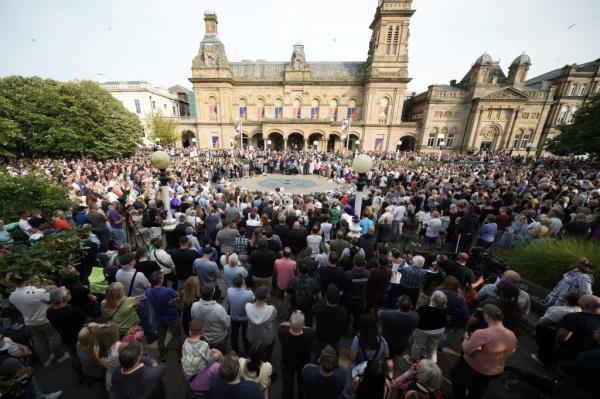 People attend a vigil outside the Atkinson building in central Southport which is being held for the child victims of a knife attack on July 30, 2024 in Southport, England