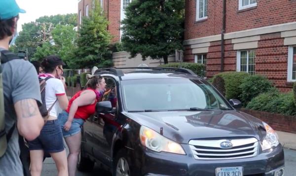 Black Lives Matter protesters are seen co<em></em>nfronting Bettinger, who remained inside her vehicle.