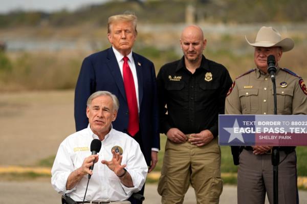 Former President Do<em></em>nald Trump listening to Texas Governor Greg Abbott's speech at the US-Mexico border in Eagle Pass, Texas, 2024