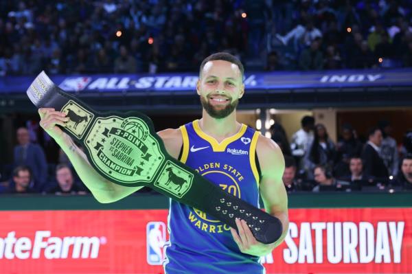 Stephen Curry holds up the winner's 