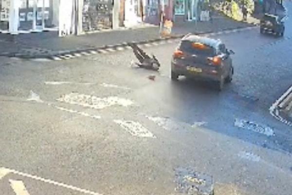 Tony Jauncey laying flat on his back in the roadway after being hit. 