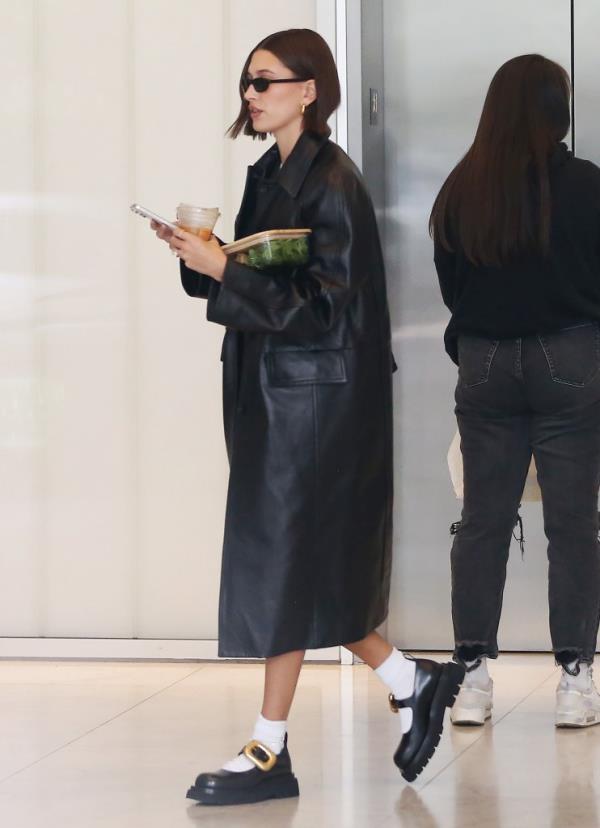 Hailey Rhode Bieber carries her food into her office in Beverly Hills.