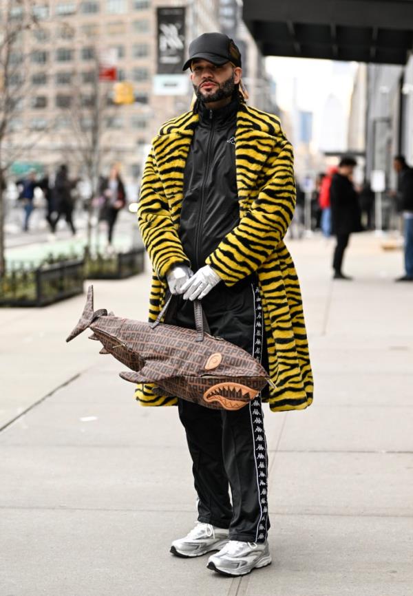 Jason Christopher Peters is seen wearing a Boohoo Man animal print coat, Playground bag, top and pants Kappa and doo rag Jason C. Peters outside the Chiara Boni show during New York Fashion Week