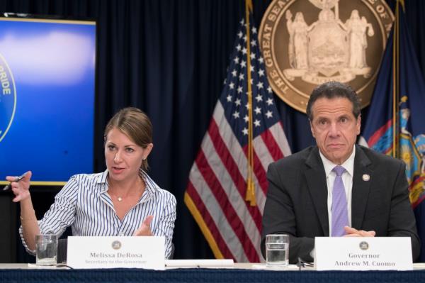 In this Sept. 14, 2018 file photo, Secretary to the Governor Melissa DeRosa, is joined by New York Gov. Andrew Cuomo as she speaks to reporters during a news conference, in New York. De Rosa, Cuomo's top aide, told top Democrats frustrated with the administration's long-delayed release of data a<em></em>bout nursing home deaths that the administration 