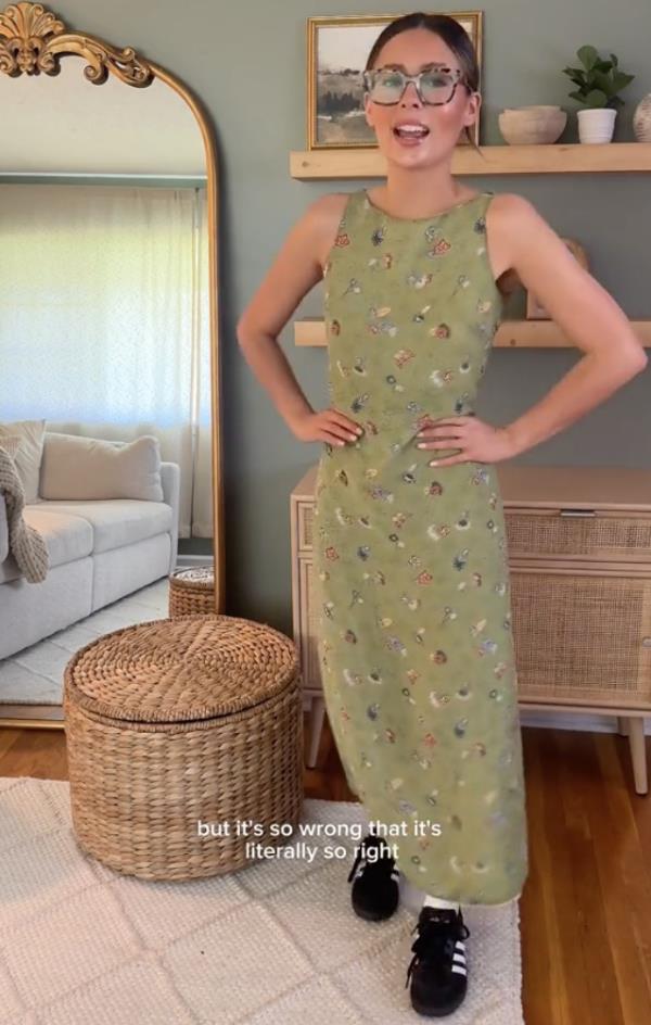Woman in green dress and black adidas shoes