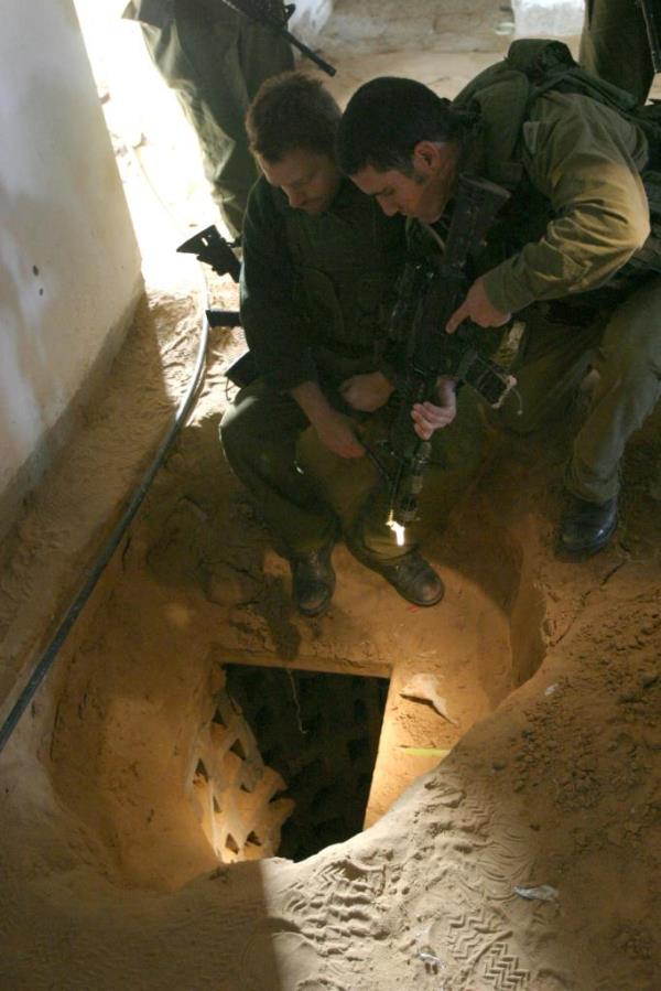 Israeli soldier looking at a Hamas tunnel in the floor of a home in Rafah