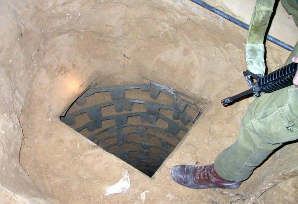 Israeli soldiers investigateing a tunnel in a private Palestinian home.