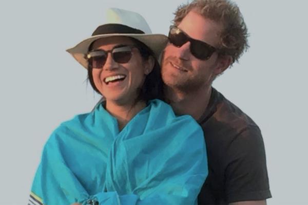 Prince Harry and Meghan, Duke and Duchess of Sussex, smiling for a picture, referencing their Netflix show