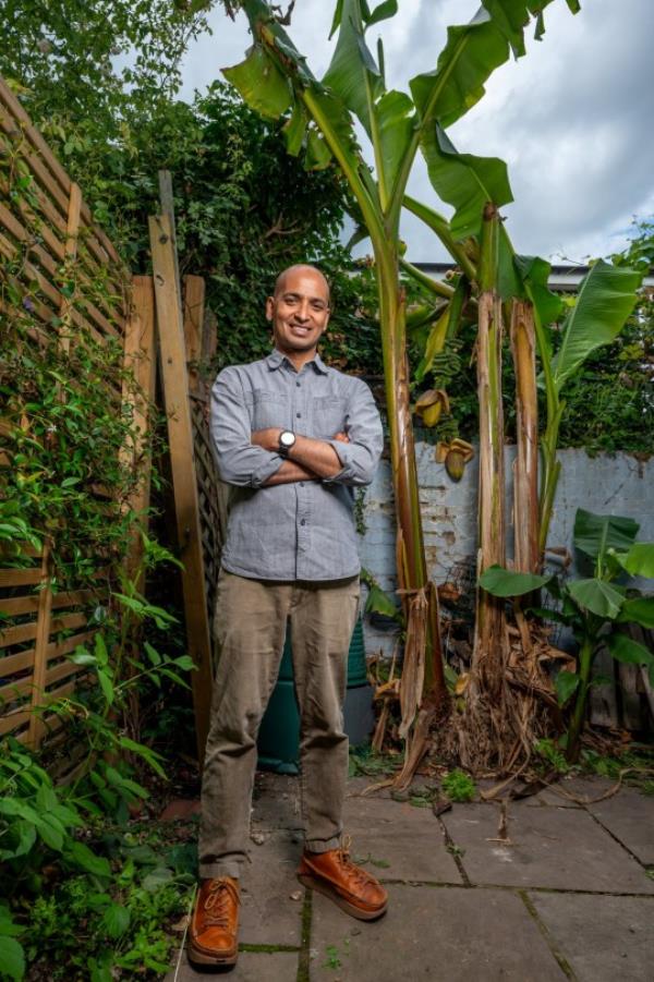 **Sent under embargo - no use before 14.00 BST July 28 2023** Ripon Ray in his garden in Hackney, Lo<em></em>ndon with his fruiting banana tree. See SWNS copy SWSYbananas: A man has been left stunned after his garden banana tree started producing fruit ? in Hackney. Ripon Ray, 42, said he?d never seen the tree produce fruit before until this summer?s heatwave hit. Since then, his banana tree has started growing the tropical fruit - in East London.