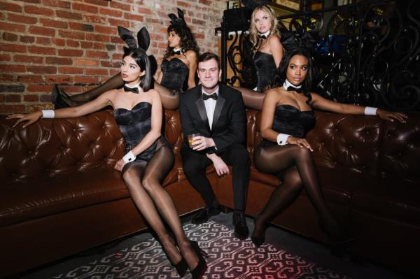Cooper Hefner posing with Playboy models.